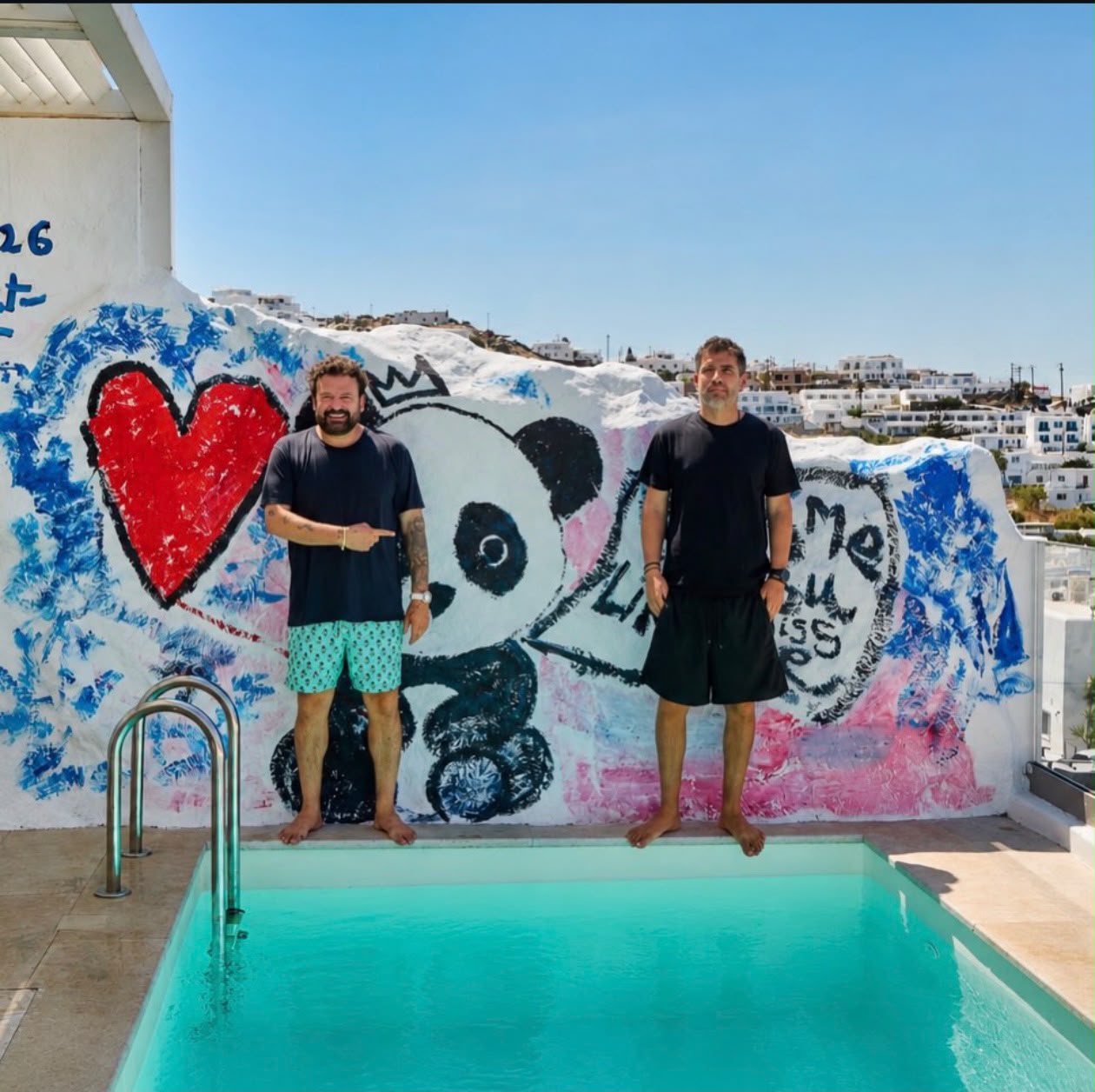Giorgos Andritsos and Domingo Zapata beside a pool in Mykonos